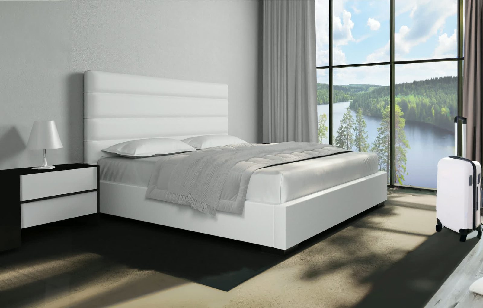 A serene minimalist bedroom with a white upholstered platform bed, soft grey bedding, and floor-to-ceiling windows overlooking a forested lake