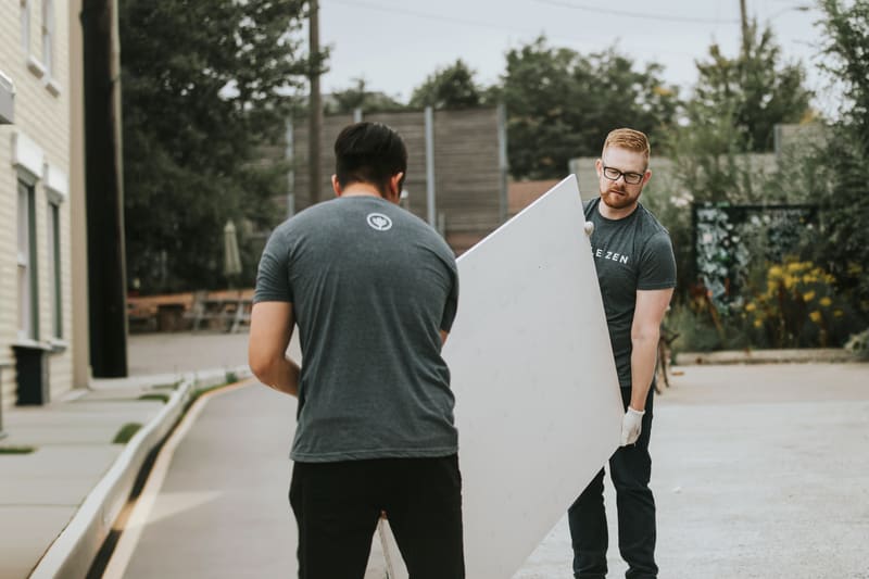 White-glove delivery: the team bringing in a headboard