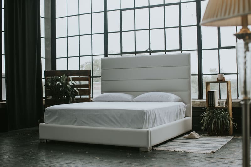 White vegan leather Zazen Bed in a loft, seen from the foot of the bed