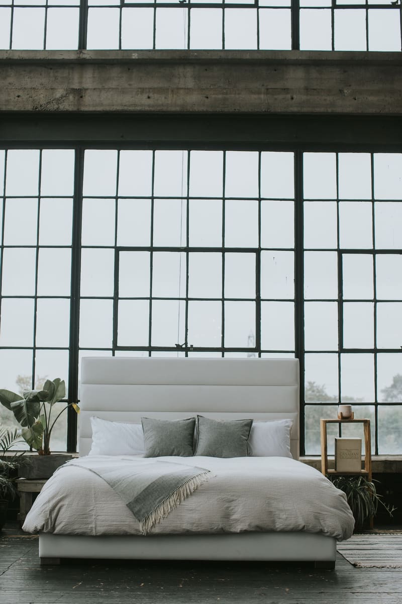 Made up with grey pillows and a throw