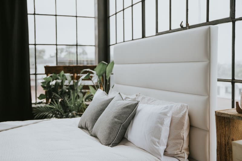 Pillows stacked against the horizontal channel headboard