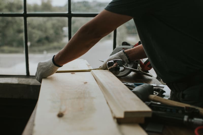 Measuring lumber in the workshop
