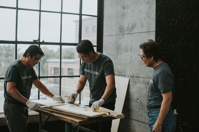 Three craftsmen at the bench